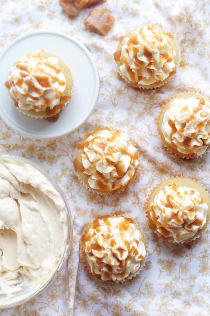 The best Salted Caramel Cupcakes ever- with caramel in the center of the cupcake, in the frosting, and drizzled on top!